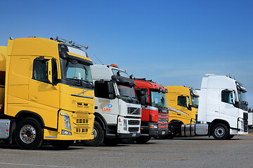 Image showing Line Up of Colorful Semi Trucks