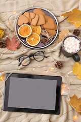 Image showing tablet computer, hot chocolate and autumn leaves