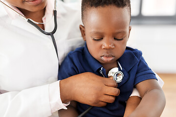 Image showing doctor with stethoscope and baby patient at clinic