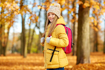 Image showing happy student girl with schoolbag at autumn park