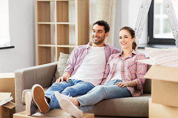 Image showing happy couple with boxes moving to new home