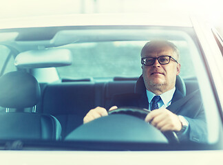 Image showing happy senior businessman driving car