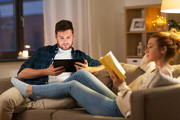 Image showing couple with tablet computer and book at home