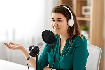 Image showing woman with microphone recording podcast at studio