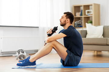 Image showing man drinking water during training at home