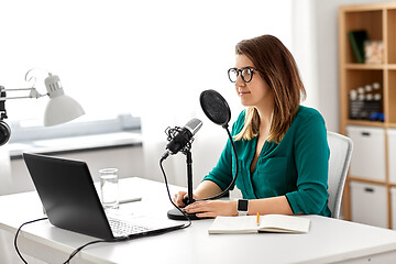 Image showing woman with microphone recording podcast at studio