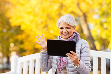 Image showing senior woman with tablet pc at summer park