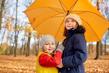 Image showing happy children with umbrella at autumn park