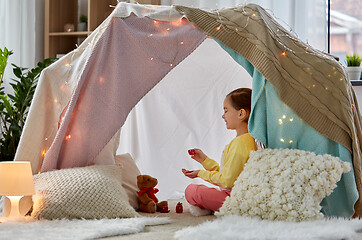 Image showing girl playing tea party with teddy in kids tent