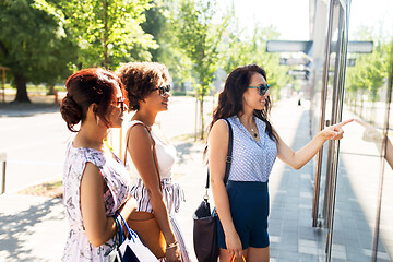 Image showing women with shopping bags looking at shop window