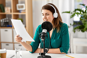 Image showing woman with microphone recording podcast at studio