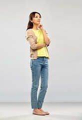 Image showing asian woman thinking over grey background