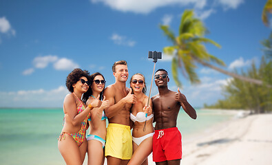 Image showing friends taking selfie on beach and show thumbs up