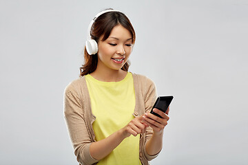 Image showing asian woman in headphones listening to music