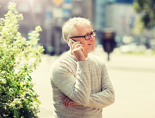 Image showing happy senior man calling on smartphone in city