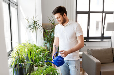 Image showing man watering houseplants at home