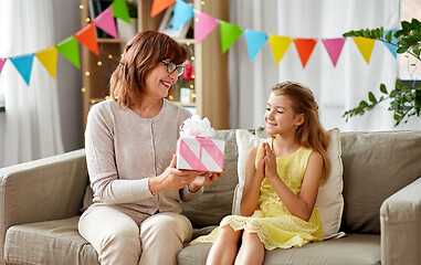 Image showing grandmother giving granddaughter birthday gift