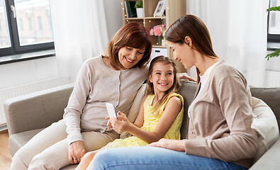 Image showing mother, daughter and grandmother with smartphone