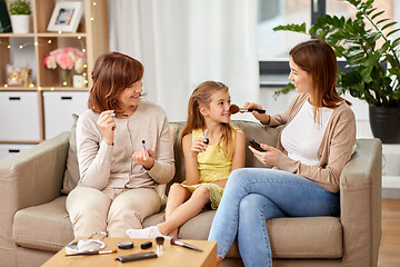 Image showing mother, daughter and grandmother doing make up