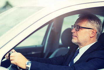 Image showing happy senior businessman driving car