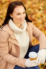 Image showing woman drinking takeaway coffee in autumn park