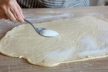 Image showing sugar is poured on the yeast dough