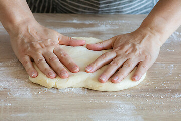 Image showing yeast dough and human arms