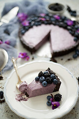 Image showing Plate with homemade piece of delicious blueberry, blackberry and grape pie or tart served on table