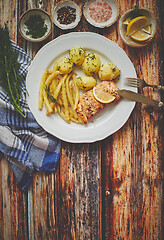 Image showing Fresh and tasty baked salmon served with young boiled potatoes and yellow bean.