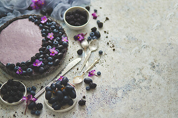 Image showing Sweet and tasty tart with fresh blueberries, blackberries and gr