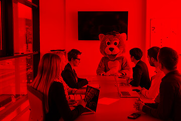 Image showing boss dresed as bear having fun with business people in trendy of