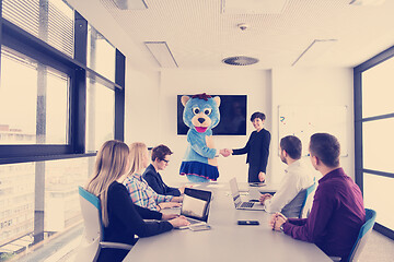 Image showing boss dresed as bear having fun with business people in trendy of