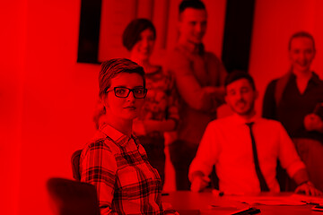 Image showing portrait of young business woman at office with team on meeting 