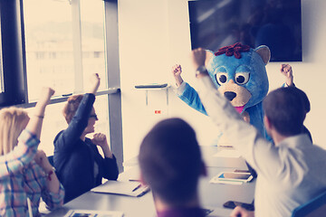 Image showing boss dresed as bear having fun with business people in trendy of