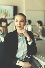 Image showing portrait of young business woman at office with team on meeting 