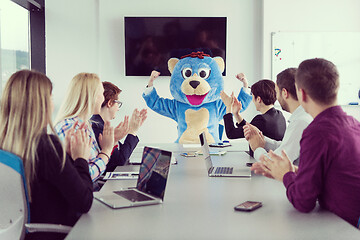 Image showing boss dresed as bear having fun with business people in trendy of