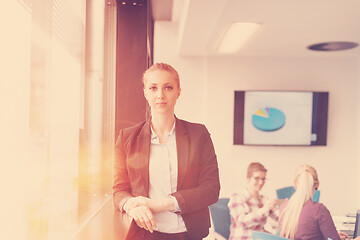 Image showing portrait of young business woman at office with team on meeting 