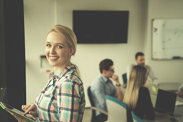 Image showing Pretty Businesswoman Using Tablet In Office Building by window