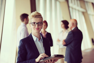 Image showing portrait of older business woman  at office with tablet computer