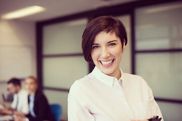 Image showing hispanic businesswoman with tablet at meeting room