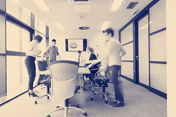 Image showing business people group entering meeting room  motion blur