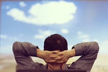 Image showing young man dreaming clouds on presentation