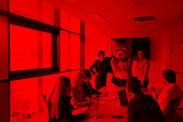 Image showing boss dresed as bear having fun with business people in trendy of