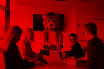 Image showing boss dresed as bear having fun with business people in trendy of