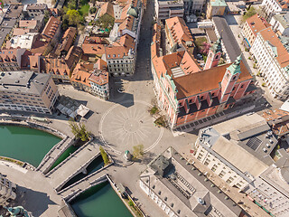 Image showing Aerial drone view of Preseren Squere and Triple Bridge over Ljubljanica river,Tromostovje, Ljubljana, Slovenia. Empty streets during corona virus pandemic social distancing measures