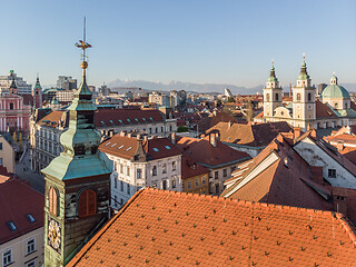 Image showing Scenic panoramic aerial drone view of rooftops of medieval city center, town hall and cathedral church in Ljubljana, capital of Slovenia, at sunset