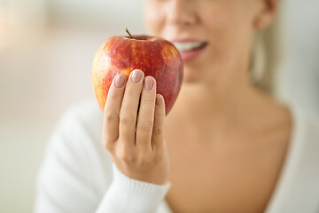 Image showing close up of woman holding ripe red apple