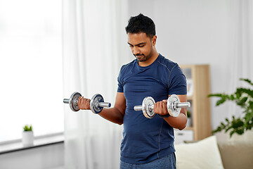 Image showing indian man exercising with dumbbells at home