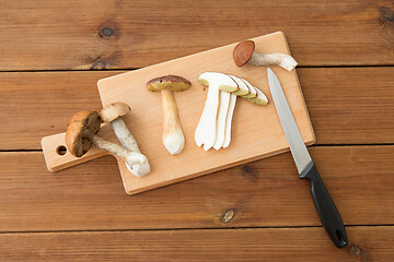 Image showing edible mushrooms, kitchen knife and cutting board