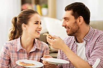 Image showing happy couple eating pizza at home